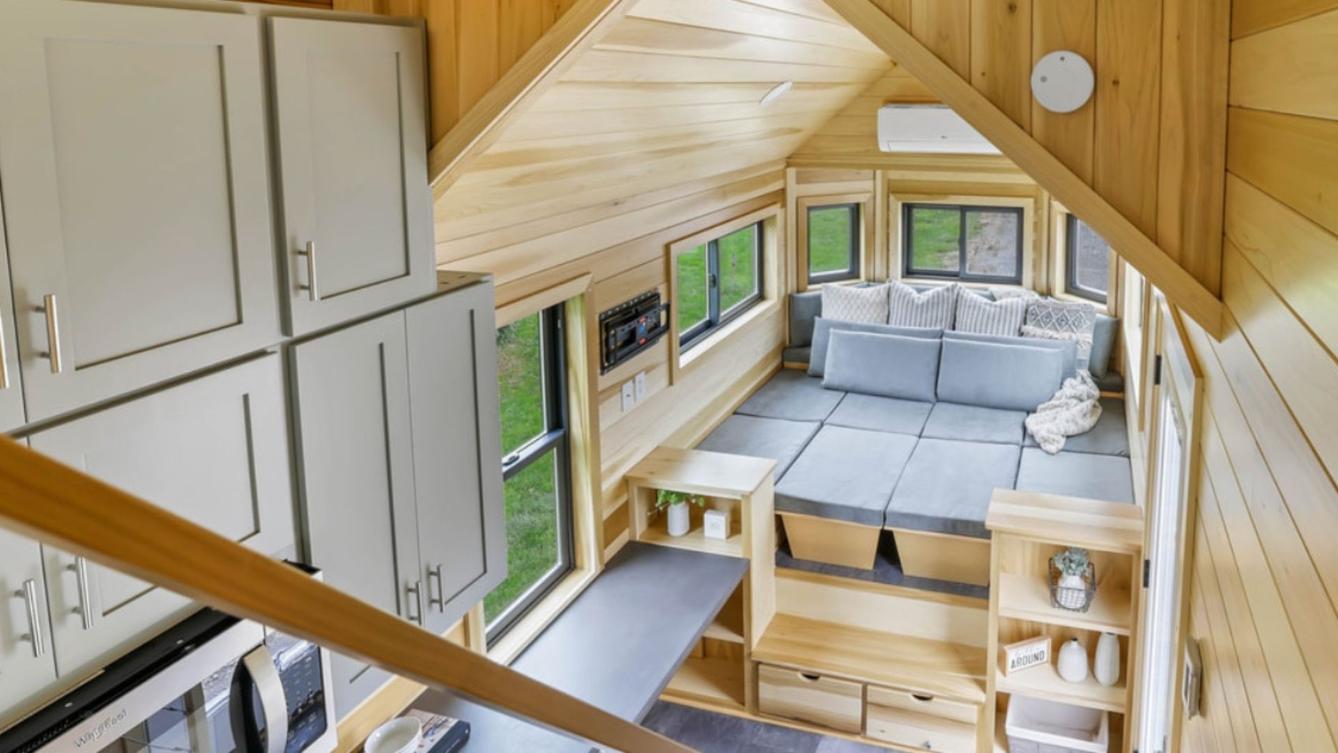 tiny home architecture with bed, kitchen and kitchen cabinets